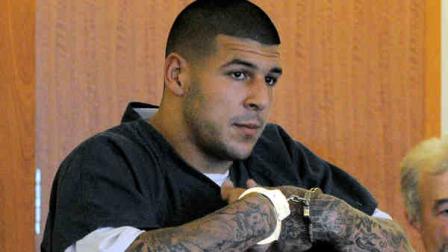 Former New England Patriots football tight end Aaron Hernandez stands during a bail hearing in Fall River Superior Court Thursday, June 27, 2013 in Fall River, Mass. Hernandez, charged with murdering Odin Lloyd, a 27-year-old semi-pro football player, was denied bail. (AP Photo/Boston Herald, Ted Fitzgerald, Pool)