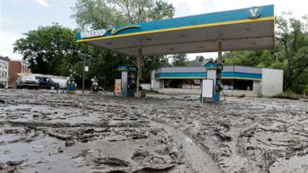 Mud fills the parking lot of a convenience store after flooding on Friday, June 28, 2013, in Fort Plain, N.Y. Severe flooding caused by the spring and early summers persistent rains damaged houses, closed roads and forced people to flee their homes Friday in New Yorks Mohawk Valley. Heavy rains Thursday and into early Friday caused the Mohawk River to overflow it banks where it traverses the southern end of Herkimer County, located 60 miles east of Syracuse. (AP Photo/Mike Groll)