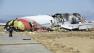 This image released by the National Transportation Safety Board Sunday, July 7, 2013, shows NTSB workers near the Boeing 777 Asiana Airlines Flight 214 aircraft. The Asiana flight crashed upon landing Saturday, July 6, at San Francisco International Airport, and two of the 307 passengers aboard were killed. (AP Photo/NTSB)