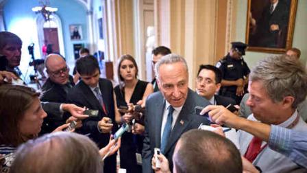 Sen. Chuck Schumer, D-N.Y., chairman of the Senate Rules Committee, speaks with reporters just off the Senate floor as lawmakers moved toward resolving their feud over Republican filibusters of White House appointees, at the Capitol in Washington, Tuesday, July 16, 2013. The Senate just voted 71-29 to end a two-year Republican blockade that was preventing Richard Cordray from winning confirmation as director of the Consumer Financial Protection Bureau. (AP Photo/J. Scott Applewhite)