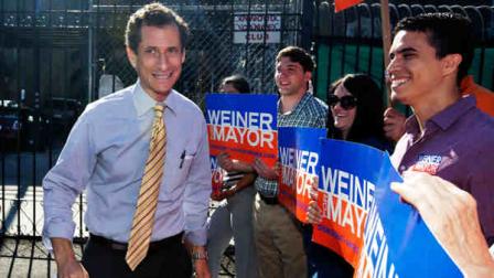 New York mayoral candidate Anthony Weiner walks by supporters as he arrives for a candidate forum on small business, in the Inwood section of the borough of Manhattan, in New York, Tuesday, July 30, 2013. Weiner plunged to fourth place among Democrats in a poll taken since he admitted to having illicit online exchanges with women even after he resigned from Congress amid a sexting scandal. (AP Photo/Richard Drew)