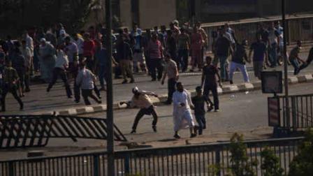 Supporters of ousted President Mohammed Morsi throw stones against other civilians in Cairo in Egypt, Friday, Aug. 16, 2013. (AP Photo/Manu Brabo)