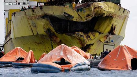 A cluster of life rafts floats near the cargo ship Sulpicio Express Siete Saturday Aug. 17, 2013, a day after it collided with a passenger ferry off the waters of Talisay city, Cebu province in central Philippines. Divers combed through a sunken ferry Saturday to retrieve the bodies of more than 200 people still missing from an overnight collision with a cargo vessel near the central Philippine port of Cebu that sent passengers jumping into the ocean and leaving many others trapped. At least 28 were confirmed dead and hundreds rescued. The captain of the ferry MV Thomas Aquinas, which was approaching the port late Friday, ordered the ship abandoned when it began listing and then sank just minutes after collision with the MV Sulpicio Express, coast guard deputy chief Rear Adm. Luis Tuason said.