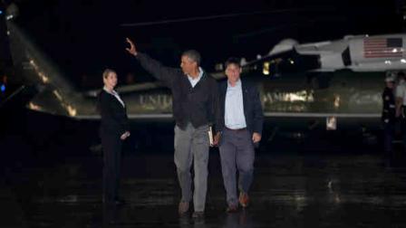 President Barack Obama waves before boarding Air Force One at Cape Cod Coast Guard Air Station, Mass., on Sunday Aug. 18, 2013, at the conclusion of his family vacation on the island of Marthas Vineyard. (AP Photo/Jacquelyn Martin)
