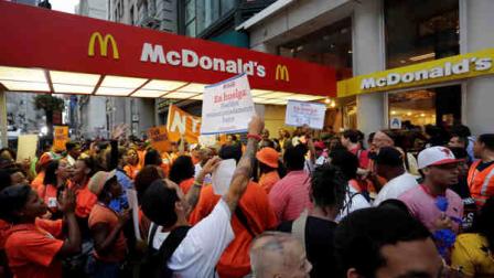 Protesting fast food workers demonstrate outside a McDonalds restaurant on New Yorks Fifth Avenue, Thursday, Aug. 29, 2013. Organizers say thousands of fast-food workers are set to stage walkouts in dozens of cities around the country Thursday, part of a push to get chains such as McDonalds, Taco Bell and Wendys to pay workers higher wages. (AP Photo/Richard Drew)