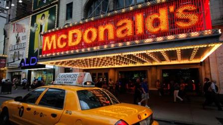 In this July 11, 2013 photo, a McDonalds marquis is illuminated in New Yorks Times Square. (AP Photo/Mark Lennihan)