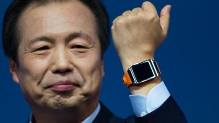 JK Shin, head of Samsung Mobile Communications, presents the Samsung Galaxy Gear in Berlin, Germany, Wednesday, Sept. 4, 2013. Samsung has unveiled a highly anticipated digital wristwatch well ahead of a similar product expected from rival Apple. The so-called smartwatch is what some technology analysts believe could become this years must-have holiday gift. Samsung unveiled the Galaxy Gear on Wednesday in Berlin ahead of the annual IFA consumer electronics show. (AP Photo/Gero Breloer)