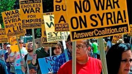Anti-war demonstrators in Washington protest against possible U.S. military action in Syria in front of the White House Saturday, Sept. 7, 2013. (AP Photo/Charles Dharapak)