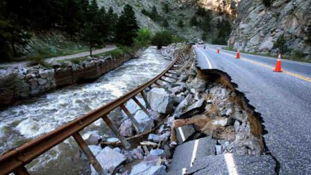 A guardrail hangs away from a closed canyon road, which links Boulder with the mountain town of Nederland, and which is washed out in places by recent flooding, up Boulder Canyon, west of Boulder, Colo., Friday Sept. 20, 2013. (AP Photo/Brennan Linsley)