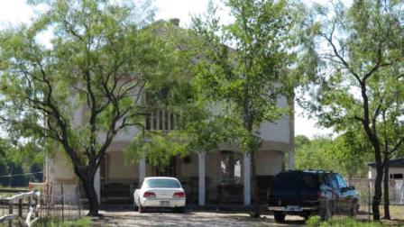 Five people were found dead Sunday inside this home near Rice, Texas, photographed Monday, September 23, 2013. Authorities are investigating the deaths as murder-suicide, Navarro County Sheriff Elmer Tanner said. (AP Photo/Nomaan Merchant)