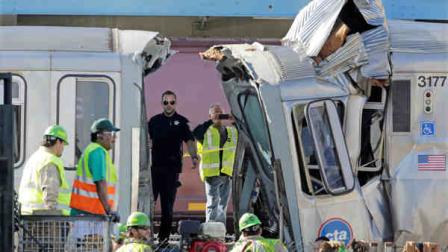Authorities inspect the wreckage of two Chicago Transit Authority trains that crashed Monday, Sept. 30, 2013, in Forest Park, Ill. (AP Photo/M. Spencer Green)
