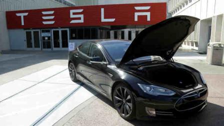 In this May 2, 2013 photo, a Tesla car is shown outside of Tesla motors in Fremont, Calif. (AP Photo/Jeff Chiu)