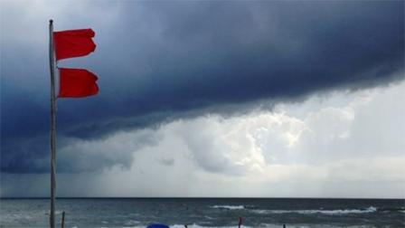 Red flags warn swimmers to stay out of the Gulf of Mexico as a squall from Tropical Storm Karen moves offshore at Gulf Shores, Ala., on Saturday, Oct. 5, 2013. The beaches remained open, but authorities said dangerous underwater rip currents made the waters too dangerous to enter. (AP Photo/Jay Reeves)