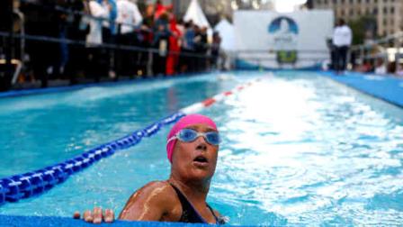 Long-distance swimmer Diana Nyad, who recently completed a record-breaking swim from Cuba to Florida, completes a lap during a continuous 48-hour marathon swim event in New Yorks Herald Square called Swim for Relief, which aims to raise funds and awareness for Hurricane Sandy recovery efforts, Tuesday, Oct. 8, 2013. (AP Photo/Jason DeCrow)