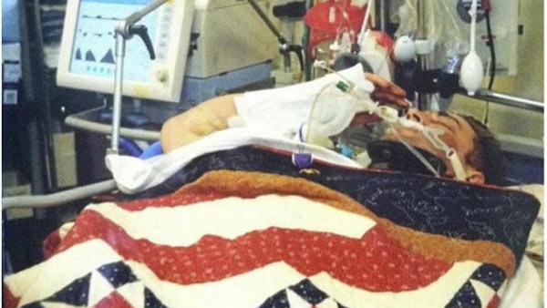 Injured soldier salutes as he receives Purple Heart