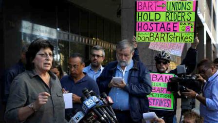 Roxanne Sanchez, left, president of Service Employees International Union Local 1021, left, speaks during a news conference on Thursday, Oct. 17, 2013, in Oakland, Calif. San Francisco Bay Area Rapid Transit workers may go on strike at midnight unless management agrees to enter into arbitration to resolve a remaining issue, a union leader said Thursday. (AP Photo/Ben Margot)