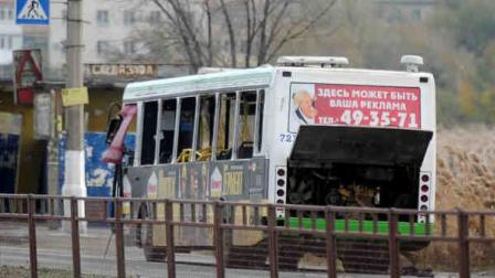 A damaged bus is examined by experts in Volgograd, Monday, Oct. 21, 2013. The blast was caused by an unspecified explosive device, the National Anti-Terrorism Committee said in a statement. A total of 40 people were on the city bus at the time of the explosion, the Emergency Situations Ministry said. At least five died and some people were injured. (AP Photo/ Sergei Ivanishin)