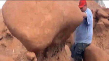 This frame grab from a video taken by Dave Hall shows a Boy Scouts leader looking over an ancient Utah desert rock formation at Goblin Valley State Park, which he later knocked down. Authorities are mulling whether to press charges against and against the two men who cheered him on after they posted video of the incident online. (AP Photo/Dave Hall)