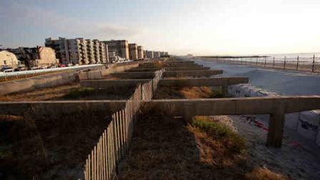 A wrecked section of the boardwalk in the Rockaways section of the Queens borough of New York is still in need of repair, Tuesday, Oct. 29, 2013. Superstorm Sandy pummeled the region a year ago, destroying the boardwalk. (AP Photo/Mark Lennihan)