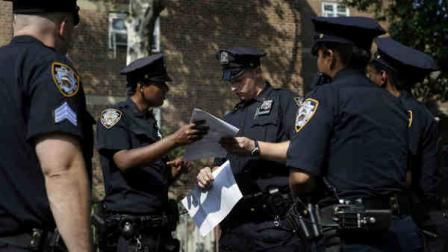 FILE - In this Aug. 13, 2013 file photo, police officers take a report from a woman who had her phone stolen in the Brownsville section of Brooklyn, New York. A federal appeals court on Thursday, Oct. 31, 2013, blocked a judges order requiring changes to the New York Police Departments stop-and-frisk program and removed the judge from the case. (AP Photo/Seth Wenig, File)