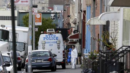 Crime scene personnel work at a crime scene in the Brooklyn section of New York, Monday, Nov. 11, 2013. A man who had apparently been kicked out of a band fatally shot three of his bandmates and wounded a fourth early Monday in a Brooklyn row house before killing himself, police said. (AP Photo/Seth Wenig)