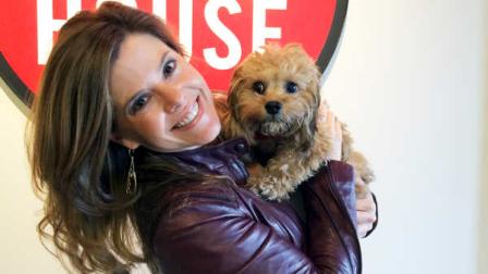 In this October 2013 photo provided by Brande Bradshaw, Bradshaw poses while holding Bridgette at home in Austin, Texas. Bradshaw thinks her cava-poo chon Bridgette, who just turned 6-months-old, is the perfect dog. (AP Photo/Courtesy Brande Bradshaw)