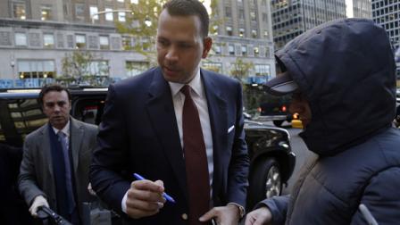 Alex Rodriguez signs autographs as he arrives at MLB headquarters in New York, Tuesday, Nov. 19, 2013. (AP Photo/Seth Wenig)