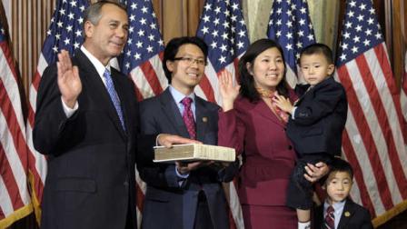 FILE - In this Jan. 3, 2013, file photo, House Speaker John Boehner of Ohio, left, performs a mock swearing in for Rep. Grace Meng, D-N.Y., right, on Capitol Hill in Washington as the 113th Congress began. (AP Photo/Cliff Owen, File)