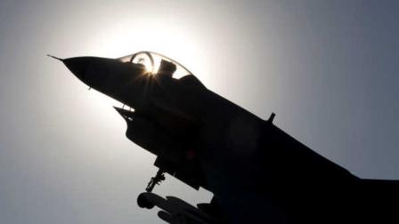 The replica of a Chinese made fighter jet is silhouetted against the sun in Beijing, China, Wednesday, Nov. 27, 2013. China said Wednesday it had monitored two unarmed U.S. bombers that flew over the East China Sea in defiance of Beijings declaration it was exercising greater military control over the area. (AP Photo/Ng Han Guan)