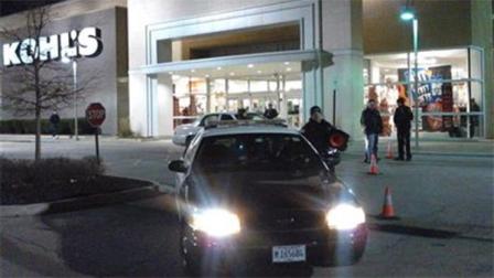 In this Nov. 28, 2013 photo police respond to a call at department store open on Thanksgiving in Romeoville, Ill., after an alleged shoplifting incident. Authorities said police officer answering a the call shot the driver of a car that was dragging a fellow officer. The wounded driver of the car and the dragged officer were both taken for hospital treatment of non-life-threatening shoulder injuries and three were arrested, according to police. (AP Photo/Chicago Sun-Times, Frank Vaisvilas)