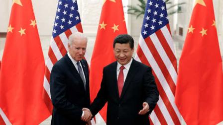 Chinese President Xi Jinping, right, shakes hands with U.S Vice President Joe Biden, left, as they pose for photos at the Great Hall of the People in Beijing, China, Wednesday, Dec. 4, 2013. (AP Photo/Lintao Zhang, Pool)