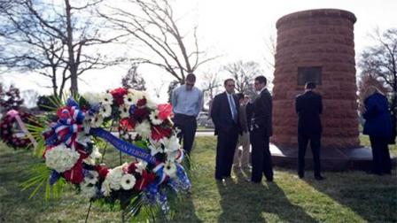 Relatives and friends of the victims of the bombing of Pan Am Flight 103 gather around the memorial cairn at Arlington National Cemetery, in Arlington, Va., Saturday, Dec. 21, 2013, during a memorial service to mark the 25th anniversary of the bombing of the Pan Am Flight 103 that crashed over Lockerbie, Scotland. New York bound Pan Am flight 103, exploded over the southern Scottish town on the evening of Dec. 21, 1988, killing 270 people aboard the plane and on the ground. (AP Photo/Manuel Balce Ceneta)