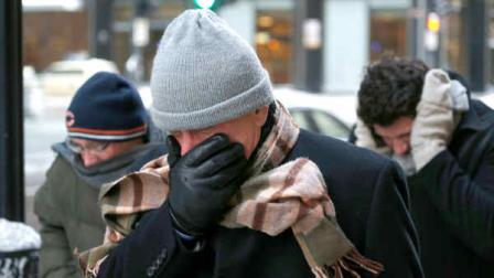Three men protect themselves from the elements as they walk in Chicagos Loop with temperatures well below zero and wind chills expected to reach 40 to 50 below Monday, Jan. 6, 2014, in Chicago. A whirlpool of frigid, dense air known as a polar vortex descended Monday into much of the U.S. (AP Photo/Charles Rex Arbogast)