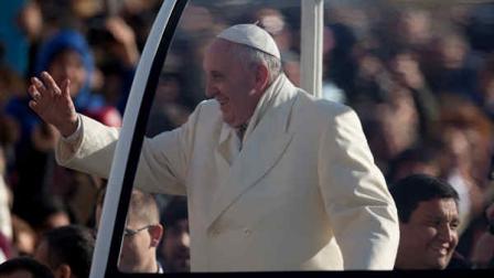 Rev. Fabian Baez, bottom right, sits behind Pope Francis on his popemobile as he arrives for his weekly general audience in St. Peters Square at the Vatican, Wednesday, Jan. 8, 2014. Pope Francis has broken with papal protocol once again, inviting his friend Rev. Fabian Baez, a priest from Francis hometown in Buenos Aires, for a spin on his popemobile. (AP Photo/Alessandra Tarantino)