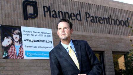 In this Sunday Jan. 23, 2011 file photo, Bryan Howard, President and CEO of Planned Parenthood Arizona, Inc., stands out in front of a Planned Parenthood facility in Tucson, Ariz. (AP Photo/Ross D. Franklin, File)
