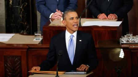 President Barack Obama takes the podium to give his State of the Union address on Capitol Hill in Washington, Tuesday Jan. 28, 2014. Vice President Joe Biden and House Speaker John Boehner of Ohio are behind the president. (AP Photo/Charles Dharapak)