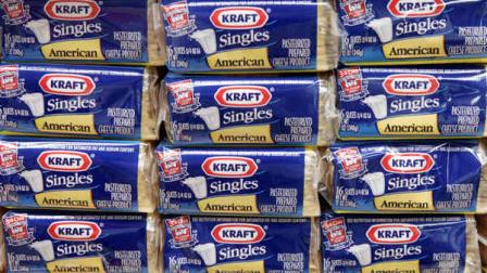 FILE - In this July 24, 2006, file photo, packages of Kraft Singles are displayed in Chicago. (AP Photo/Charles Rex Arbogast, file)