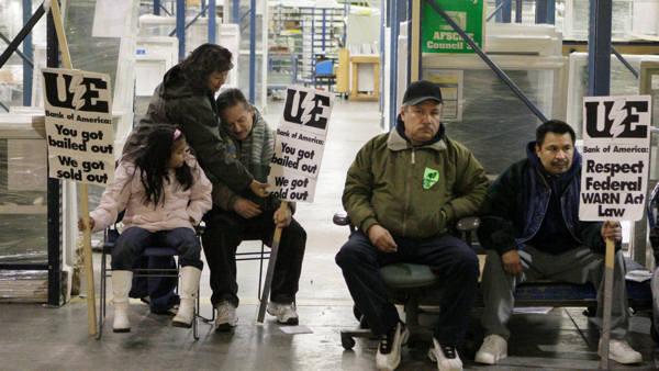 Workers an supporters line the factory floor Sunday, Dec. 7, 2008 on the third day of a sit-in at the Republic Windows and Doors factory in Chicago. The band of 200 workers demanding severance and vacation pay have become a national symbol for the millions of laid off workers across the country after the company abruptly fired them last week prompting them to occupy their former workplace. (AP Photo/M. Spencer Green)