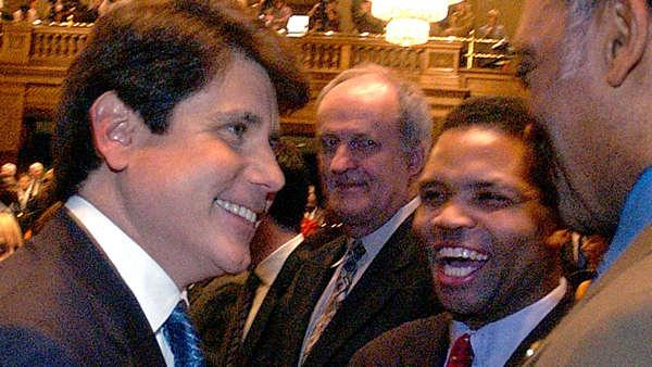 Illinois Gov. Rod Blagojevich, left, is congratulated by The Rev. Jesse Jackson, right, and Jacksons son, Rep. Jesse Jackson Jr. D-Ill., second from right, after Blagojevich delivered his State of the State address to a joint session of the Illinois General Assembly in the House of Representatives at the Illinois State Capitol in Springfield, Ill., Thursday, Feb. 3, 2005. (AP Photo/Seth Perlman)