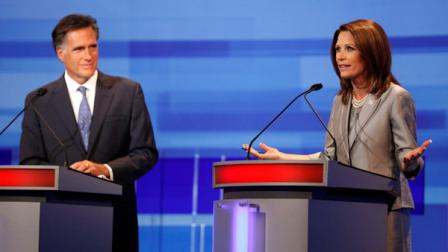 Republican presidential candidates former Massachusetts Gov. Mitt Romney, left, listens to Rep. Michele Bachmann, R-Minn., during the Iowa GOP/Fox News Debate at the CY Stephens Auditorium in Ames, Iowa, Thursday, Aug. 11, 2011. (AP Photo/Charlie Neibergall, Pool)