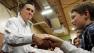 Republican presidential candidate, former Massachusetts Gov. Mitt Romney, campaigns in a gymnasium used as an overflow room at McKelvie Intermediate School in Bedford, N.H., Monday, Jan. 9, 2012. 