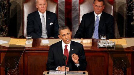 President Barack Obama gestures while giving his State of the Union address on Capitol Hill in Washington, Tuesday, Jan. 24, 2012. Vice President Joe Biden and House Speaker John Boehner of Ohio listen at rear. (AP Photo/J. Scott Applewhite)