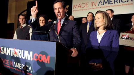 Republican presidential candidate former Pennsylvania Sen. Rick Santorum speaks as his wife Karen, right, listens during a primary night watch party Tuesday, Feb. 7, 2012, in St. Charles, Mo. (AP Photo/Jeff Roberson)