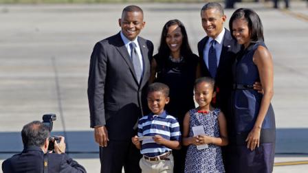 FILE - President Barack Obama and first lady Michelle Obama pose for a photo with Charlotte, N.C. Mayor Anthony Foxx, left, his wife Samara Foxx, second from left, and their children Hillary, bottom, right, and Zachary, bottom left, before leaving Charlotte, N.C., after the Democratic National Convention, Friday, Sept. 7, 2012. (AP Photo/Chuck Burton)