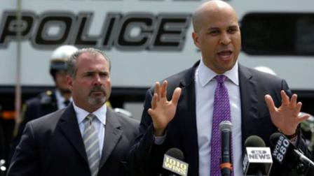 Newark Mayor Cory Booker, right, stands next to Newark Police Director Samuel DeMaio, left, during a news conference talking about the citys safety at West Side Park, Wednesday, May 29, 2013, in Newark, N.J. With the upcoming summer season, Booker said the Newark Police Department will be using a helicopter, a horseback mounted unit and a motorcycle unit on the streets to provide safety. (AP Photo/Julio Cortez)