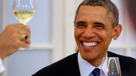 US President Barack Obama smiles during a dinner with German chancellor Angela Merkel, unseen, at Charlottenburg palace in Berlin Wednesday, June 19, 2013. (AP Photo/Michael Sohn, pool)