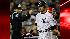 Home plate umpire Jeff Nelson signals as New...