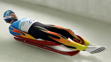 Tony Benshoof of the United States speeds down the course during a mens singles luge training run at the Vancouver 2010 Olympics in Whistler, British Columbia, Saturday, Feb. 13, 2010. (AP Photo/Charlie Krupa)