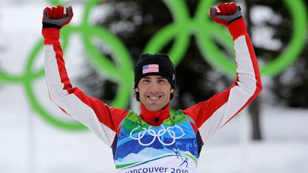United States Johnny Spillane celebrates winning the silver medal during flower ceremony of the Cross Country portion of the Nordic Combined Individual normal hill event at the Vancouver 2010 Olympics in Whistler, British Columbia, Canada, Sunday, Feb. 14, 2010. (AP Photo/Elaine Thompson)