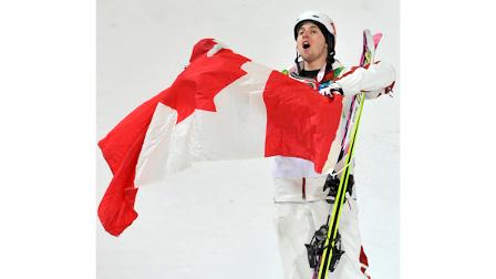 Alexandre Bilodeau of Canada celebrates becoming Olympic champion in moguls at the Vancouver 2010 Olympics in Vancouver, British Columbia, Sunday, Feb. 14, 2010. (AP Photo/Bela Szandelszky)